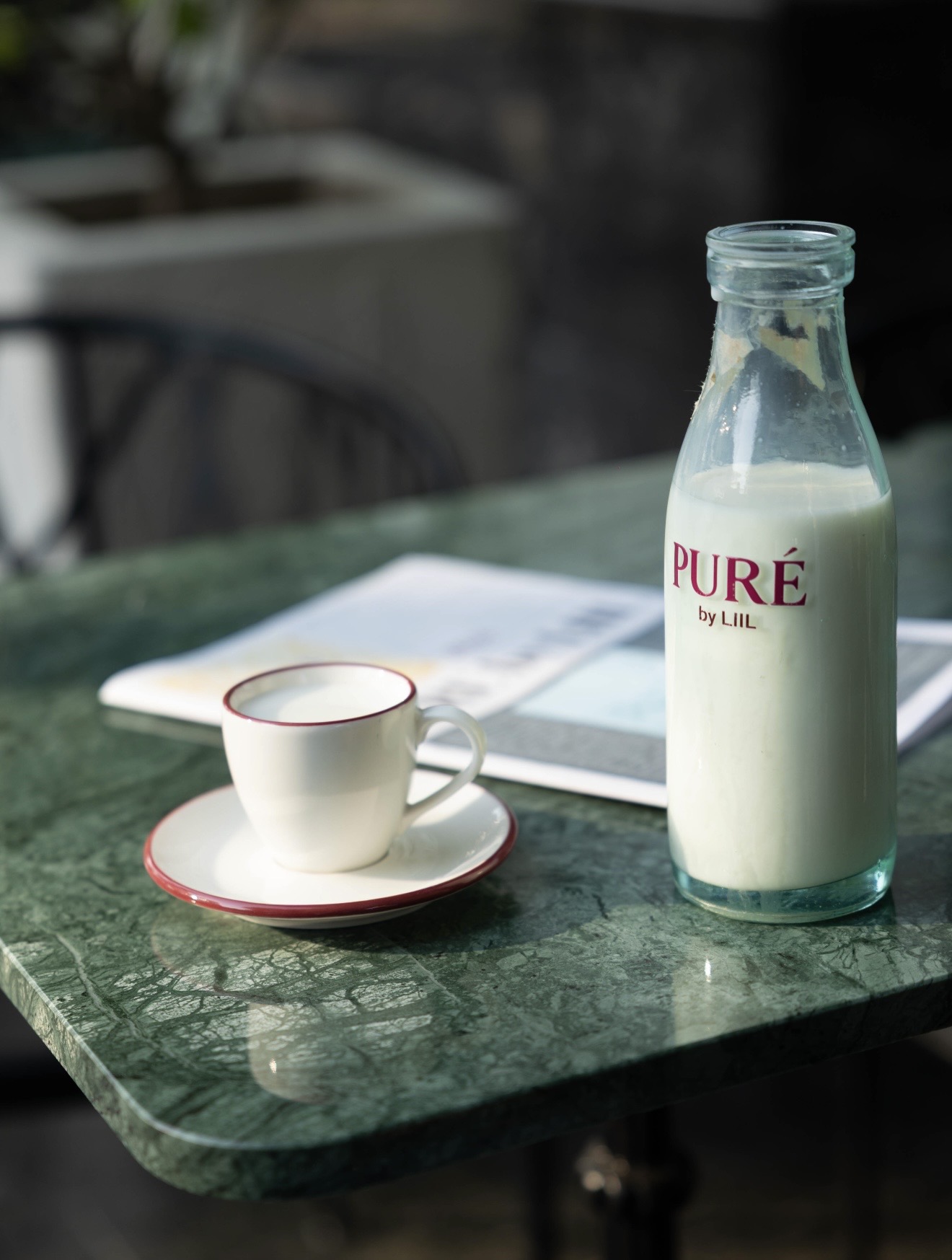 PURÉ milk bottle on marble table